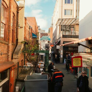 People Walking on Sidewalk Near Buildings